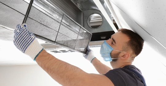 man changing ductwork filter