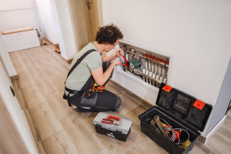 Repairmen fixing a problem with underfloor heating pipes